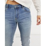 DESIGN skinny jeans in mid wash