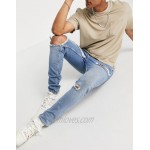 DESIGN skinny jeans with rips and destroyed hem in vintage mid wash blue