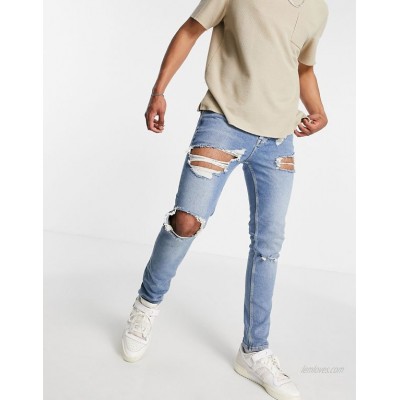  DESIGN skinny jeans with rips and destroyed hem in vintage mid wash blue  