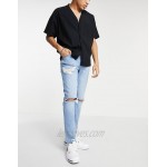 DESIGN skinny jeans with heavy rips and raw hem in light wash blue