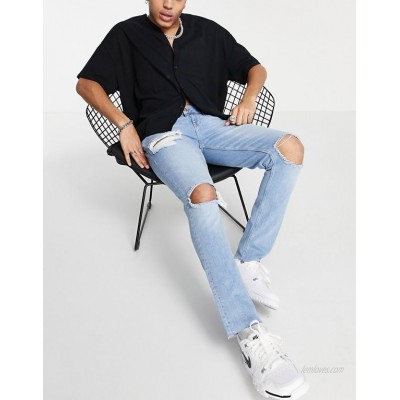  DESIGN skinny jeans with heavy rips and raw hem in light wash blue  