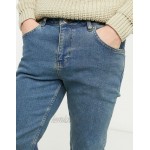 DESIGN stretch tapered jeans in tinted mid wash blue