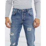 DESIGN tapered jeans in vintage mid wash blue with heavy rips
