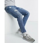 DESIGN tapered jeans in vintage mid wash blue with heavy rips