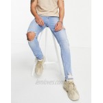 DESIGN skinny jeans in vintage mid blue with knee rip and abrasion