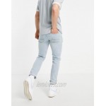 DESIGN skinny jeans with heavy rips in vintage light wash